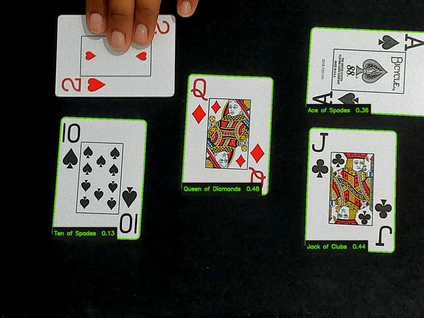 Andres placing playing cards into the webcam view while the detector labels the visible cards